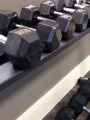 Free weights of all sizes on a weight rack at Summit Pointe in Oklahoma City, Oklahoma